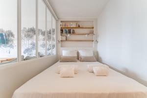 a bedroom with a large bed with two pillows at L'Embarcadère - Petit paradis 1ère ligne vue mer in Arcachon