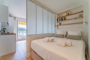a bedroom with a large bed with two towels on it at L'Embarcadère - Petit paradis 1ère ligne vue mer in Arcachon