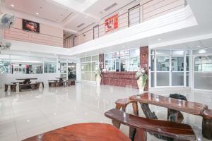 a lobby with tables and benches in a building at AC Habitat Bangkok in Bangkok