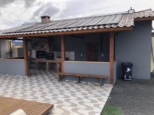 a pavilion with a bench on a patio at Casa Copacabana 2 in Urubici