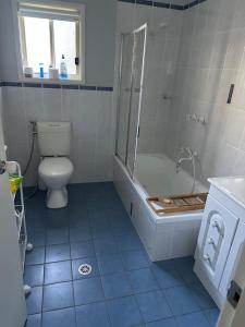 a bathroom with a shower and a toilet and a tub at Kollannoor Homestead in Mitchells Island +7 photos
