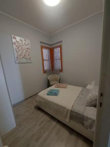 a bedroom with a bed and a chair in it at Georgia in Porto Pino