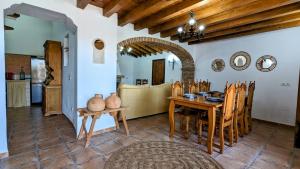 a kitchen and dining room with a table and chairs at Casa Rural Pagalván in Málaga
