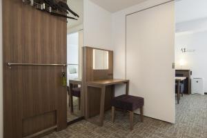 a kitchen with a refrigerator, sink and a table at Tokyu Stay Shinjuku in Tokyo