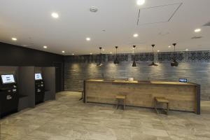 a restaurant with a bar with two benches in a room at Tokyu Stay Shinjuku in Tokyo