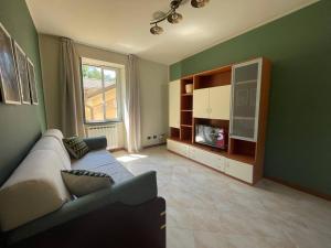 a living room with a couch and a tv at Il Rifugio by Holiday World in Castagnelo