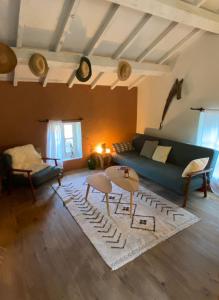 a living room with a couch and a rug at MAISON ST LAURENT in Olargues