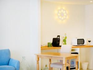 a room with a table and a blue chair at Regiohotel Manfredi in Manfredonia