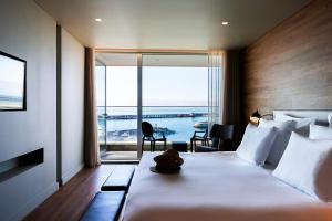 a hotel room with a bed with a view of the ocean at Octant Ponta Delgada in Ponta Delgada