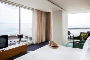 a hotel room with a bed and a large window at Octant Ponta Delgada in Ponta Delgada