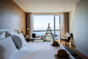 a hotel room with a bed and a large window at Octant Ponta Delgada in Ponta Delgada