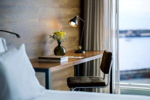 a bedroom with a desk with a vase of flowers on it at Octant Ponta Delgada in Ponta Delgada