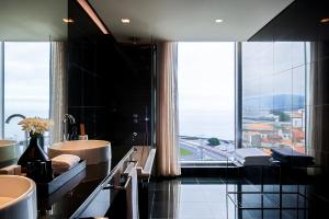a bathroom with two sinks and a large window at Octant Ponta Delgada in Ponta Delgada