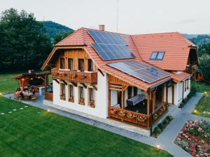 a house with solar panels on the roof at Hygge Praid in Praid