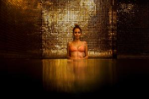 a woman in a bathtub in a brick wall at Octant Ponta Delgada in Ponta Delgada