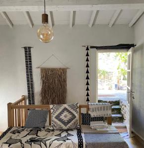 a bedroom with a bed and a lamp and a window at MAISON ST LAURENT in Olargues