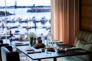 a table in a room with a view of a harbor at Octant Ponta Delgada in Ponta Delgada