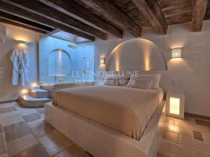 a bedroom with a large bed and a bathroom at Le Cinque Lune in Vieste