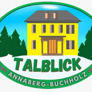 a logo for a yellow house with the words talbeck ameren building at FW-Talblick in Annaberg-Buchholz