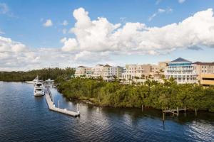 a boat docked at a dock on a river with buildings at Wyndham Grand Jupiter at Harbourside Place in Jupiter