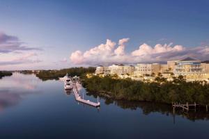 a boat docked at a dock in a river with buildings at Wyndham Grand Jupiter at Harbourside Place in Jupiter