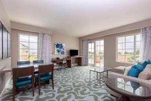 a living room with a couch and a table at Wyndham Grand Jupiter at Harbourside Place in Jupiter