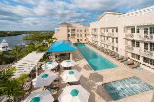 an aerial view of a hotel with a pool and umbrellas at Wyndham Grand Jupiter at Harbourside Place in Jupiter