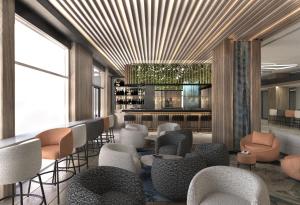 a lobby with chairs and tables and a bar at Crowne Plaza Sofia, an IHG Hotel in Sofia