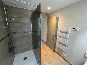a shower with a glass door in a bathroom at Gite de Claire Fontaine avec vue sur Monflanquin in Monflanquin +21 photos