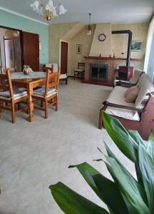 a living room with a table and a couch and a fireplace at Casa alla Costa in Mormanno