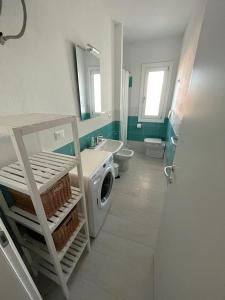 a bathroom with a washing machine and a sink at Affittimoderni La Maddalena - MADA14 in La Maddalena
