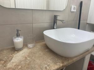 a bathroom sink with two faucets on a counter at Pigi Fotos House in Piyí +37 photos