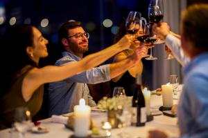 a group of people holding up wine glasses at a table at Octant Ponta Delgada in Ponta Delgada