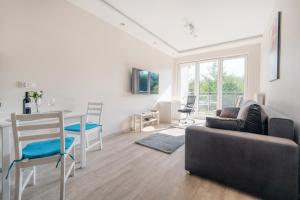 a living room with a couch and a table at Orientarium Business Apartments with Parking by Rentujemy in Łódź