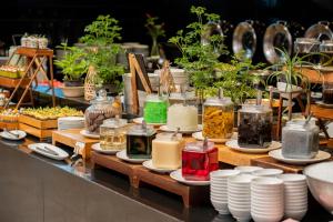 a display of plants in jars and plates on a table at Centara Life Maris Resort Jomtien in Jomtien Beach