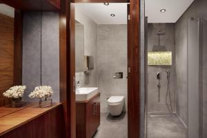 a bathroom with a toilet and a sink and a shower at Sheraton Istanbul Atakoy Hotel in Istanbul