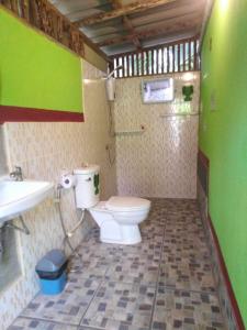 a bathroom with a toilet and a sink at Koh Mook Rem Ley in Trang