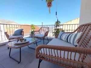 a balcony with couches and a table and chairs at Ammoudara's apartments Rooftop in Kalymnos