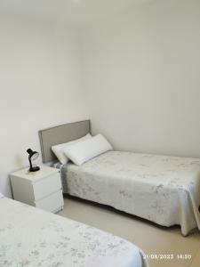 two beds sitting next to each other in a bedroom at Apartamento Agradable1 in Madrid