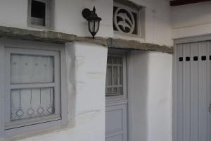 Casa blanca con ventana y puerta en Το Σπίτι του Παππού, en Stení