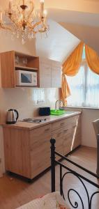 A kitchen or kitchenette at Karmelita Boutique Apartman