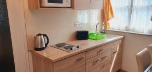 A kitchen or kitchenette at Karmelita Boutique Apartman