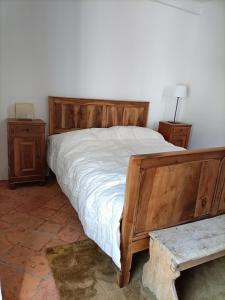 a bedroom with a wooden bed and two night stands at La Capinera in Muggio