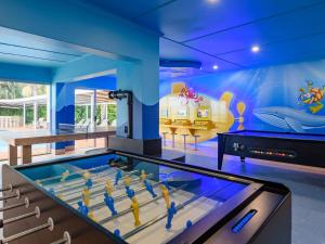 a game room with a pool table and a mural at Illovo Beach Club in Amanzimtoti