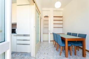 a dining room with a table and blue chairs at Garibaldi Two Bedrooms in Milan
