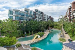 an apartment complex with a water park with a slide at Centara Life Maris Resort Jomtien in Jomtien Beach