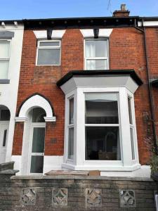 a red brick building with a white window at Newly refurbished 3 bed house in Hull