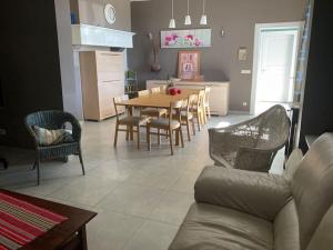 a kitchen and dining room with a table and chairs at La Casa Kemtio in Nollevaux