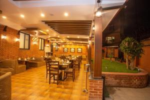 a restaurant with tables and chairs in a room at Pashupati Boutique Hotel & Spa in Kathmandu