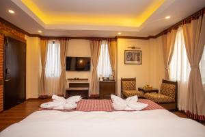a bedroom with a bed with white flowers on it at Pashupati Boutique Hotel & Spa in Kathmandu